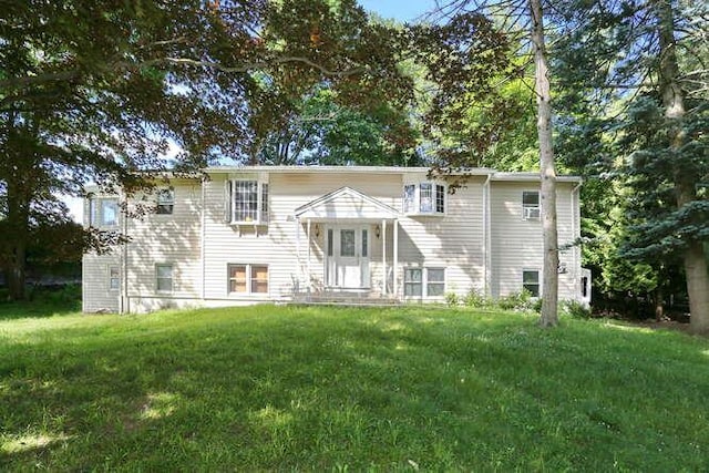 rear view of house with a lawn