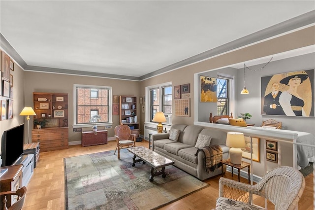 living room featuring light parquet flooring, plenty of natural light, and ornamental molding