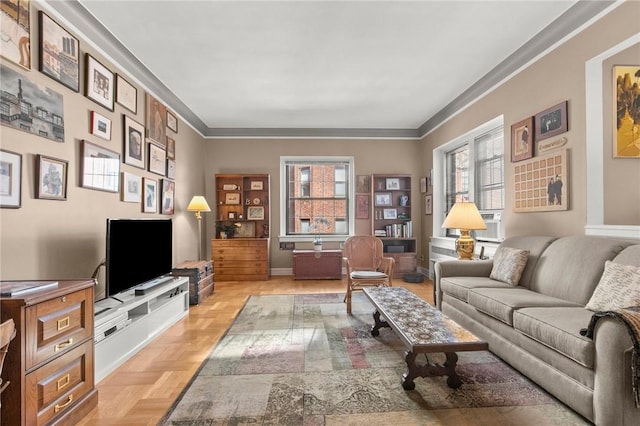 living room featuring light parquet flooring and ornamental molding