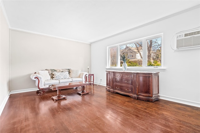 sitting room with dark wood-style floors, baseboards, ornamental molding, and an AC wall unit