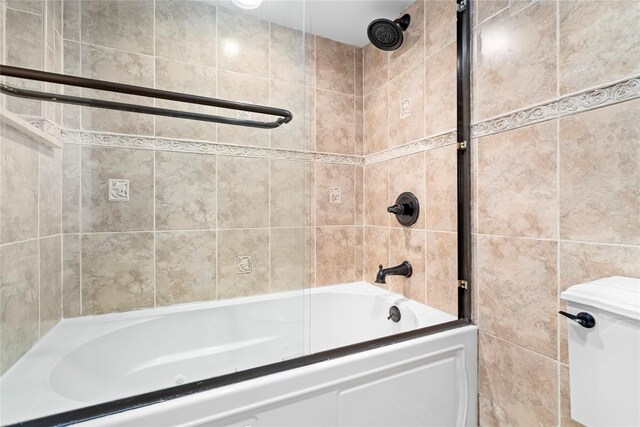 bathroom with tile walls and shower / tub combination