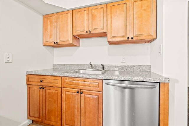 kitchen with a sink, light stone countertops, and stainless steel dishwasher