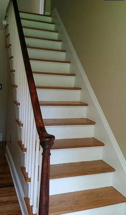 stairs with hardwood / wood-style floors