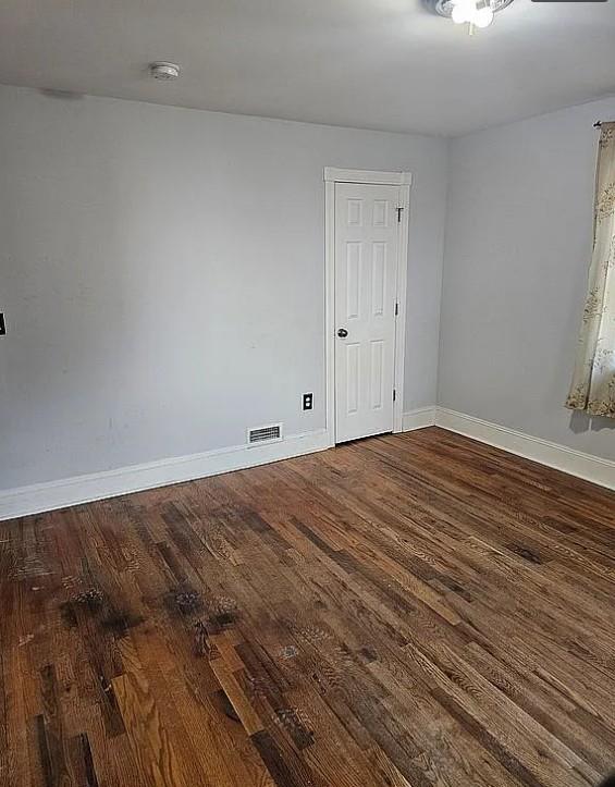 spare room featuring dark hardwood / wood-style flooring