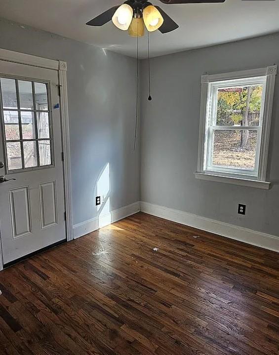 foyer with ceiling fan and dark hardwood / wood-style flooring