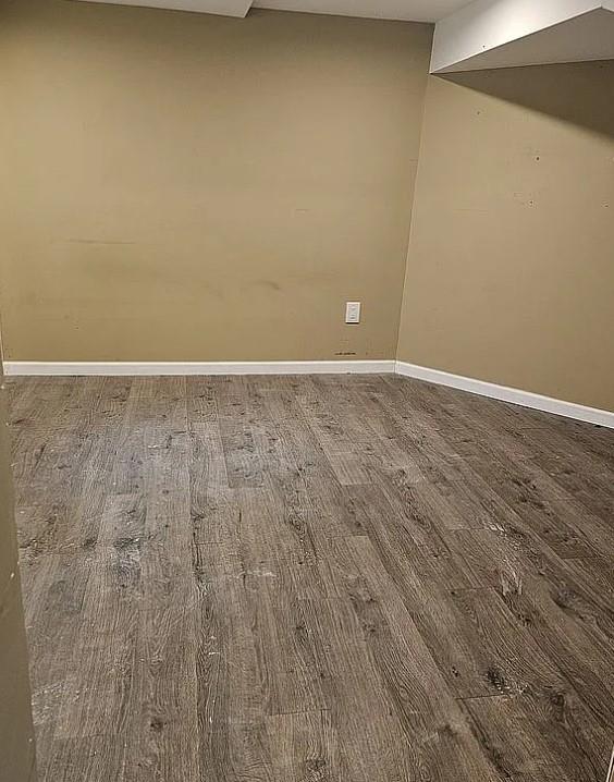 empty room with wood-type flooring