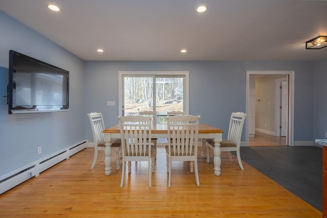 dining space featuring light hardwood / wood-style floors and a baseboard heating unit