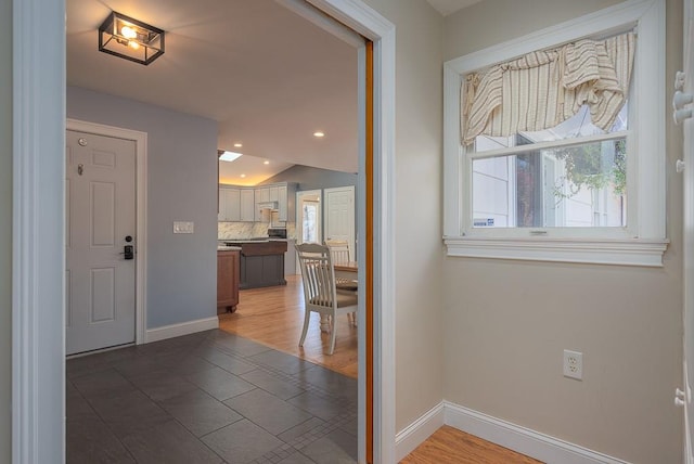 entrance foyer with lofted ceiling and hardwood / wood-style flooring