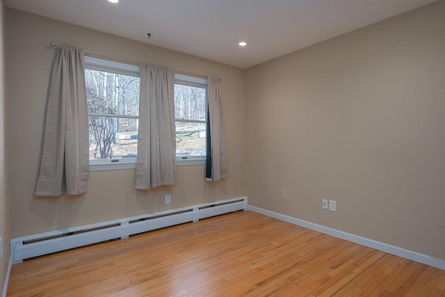 spare room with light hardwood / wood-style floors and baseboard heating