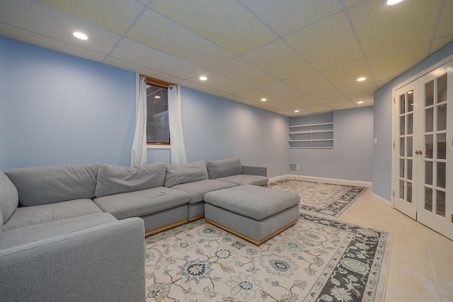 tiled living room featuring a drop ceiling