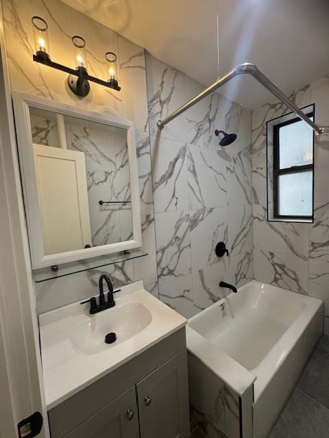 bathroom with tile walls, vanity, and shower / bathtub combination