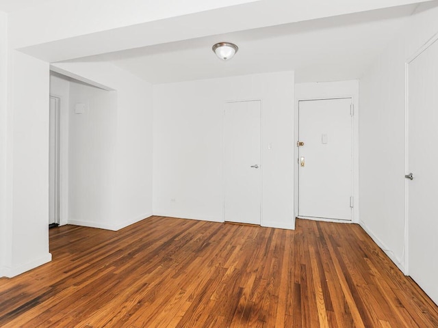 spare room featuring dark wood-type flooring