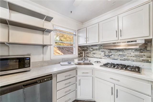 kitchen with decorative backsplash, white cabinetry, stainless steel appliances, and ornamental molding