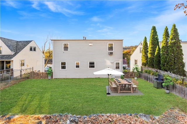 back of property with a yard and a patio