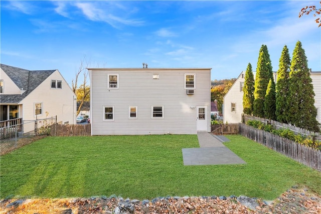 rear view of property with a lawn