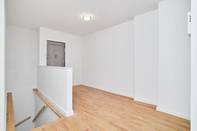 spare room featuring light hardwood / wood-style floors