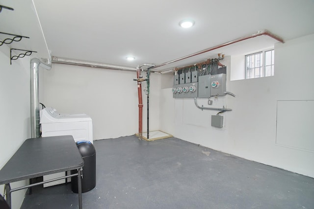 basement with washer and dryer, electric panel, and water heater