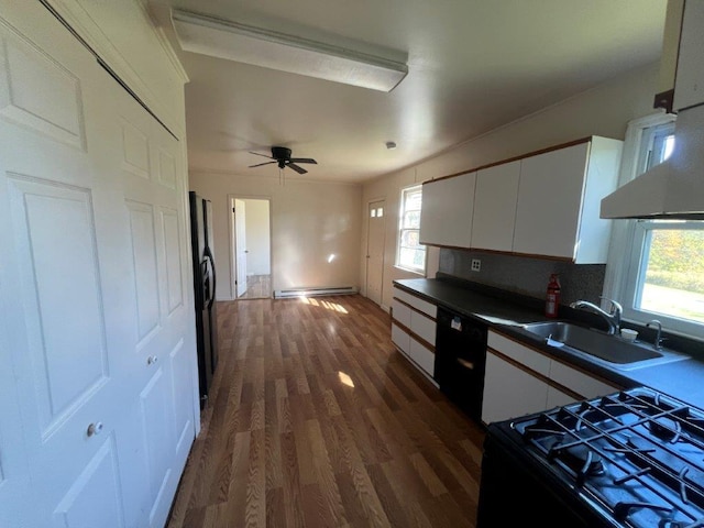 kitchen with dark hardwood / wood-style flooring, ceiling fan, sink, black appliances, and white cabinets