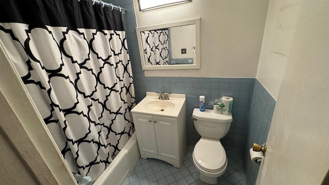 full bathroom featuring vanity, tile patterned flooring, toilet, shower / bathtub combination with curtain, and tile walls