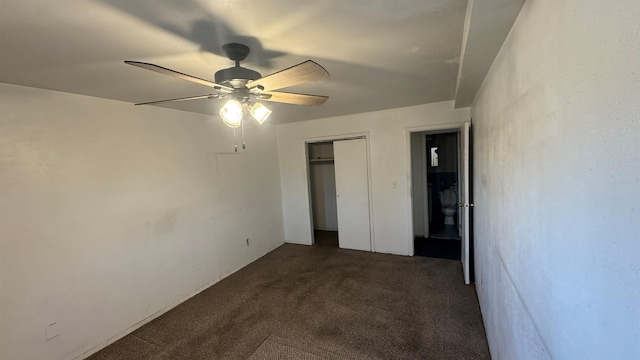 unfurnished bedroom with dark carpet and ceiling fan