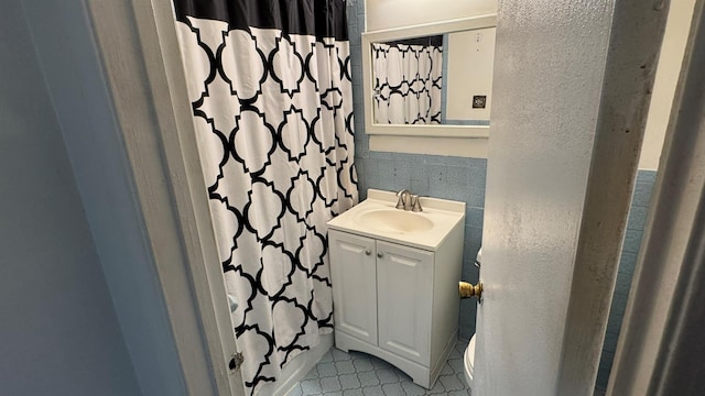 bathroom with vanity, toilet, and walk in shower