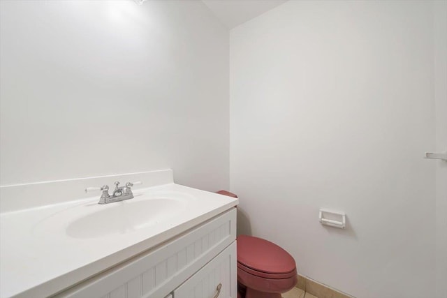 bathroom with tile patterned flooring, vanity, and toilet