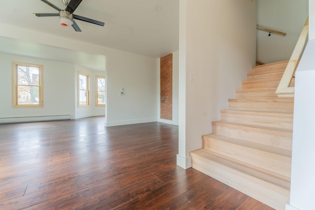 stairs featuring a baseboard heating unit, wood-type flooring, a ceiling fan, and baseboards