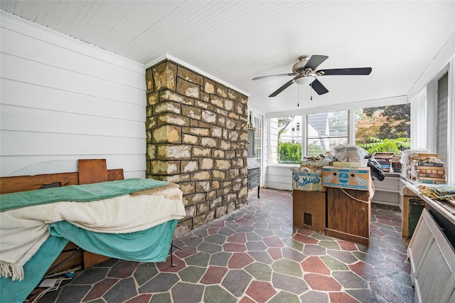 interior space with stone finish floor and a ceiling fan