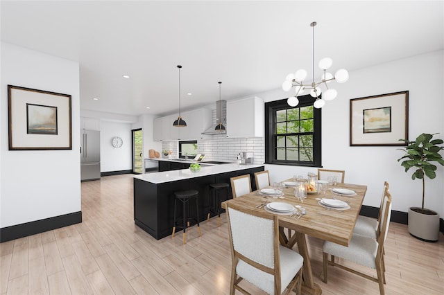 dining area featuring baseboards, recessed lighting, an inviting chandelier, and light wood-style floors