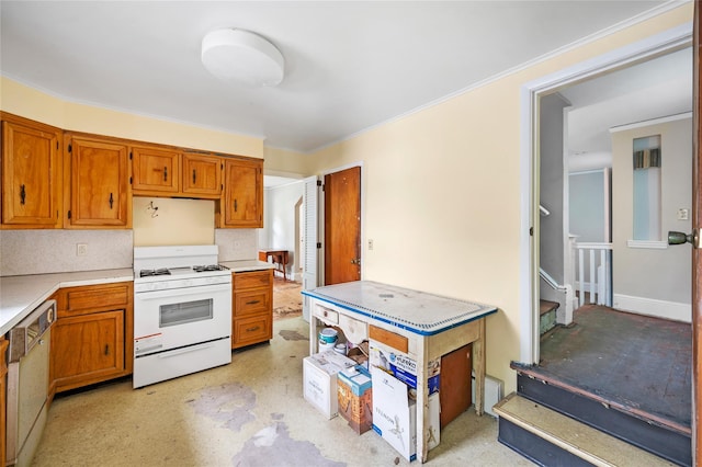 kitchen with baseboards, dishwasher, brown cabinets, white gas range, and light countertops