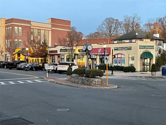 view of street featuring curbs, sidewalks, and street lights