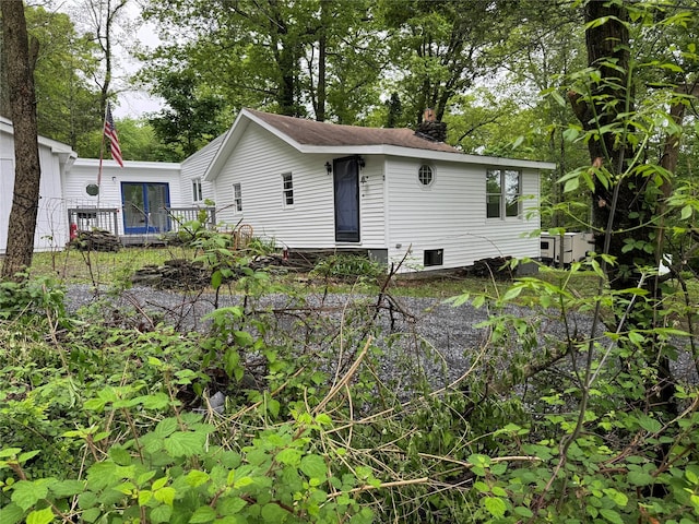3 Brookside Trl, Monroe, NY 10950 - back of house featuring a wooden deck and a chimney