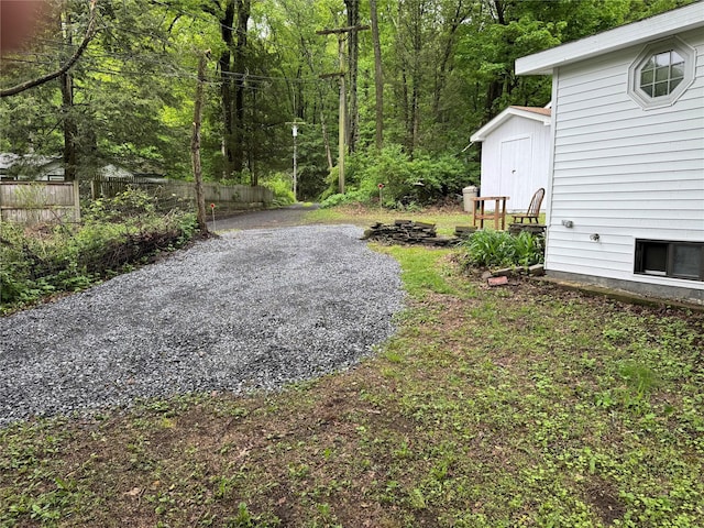 3 Brookside Trl, Monroe, NY 10950 - view of yard featuring fence, a shed, an outdoor structure, and a view of trees