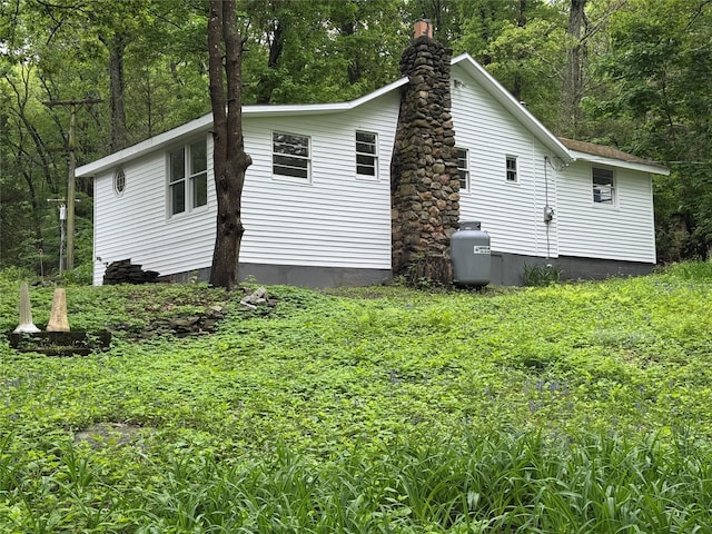 3 Brookside Trl, Monroe, NY 10950 - view of side of property with a chimney and a view of trees