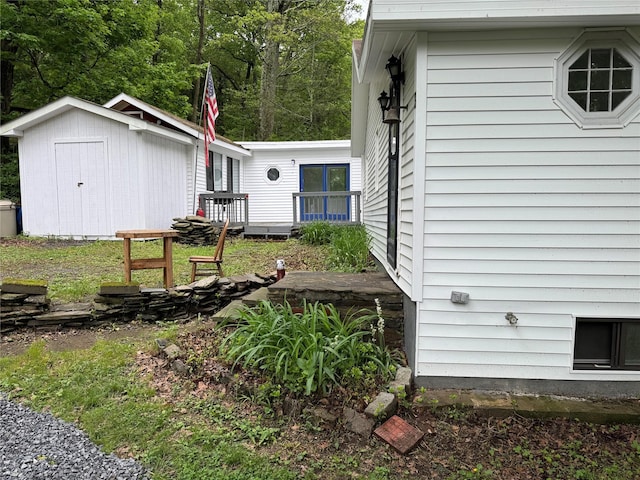 3 Brookside Trl, Monroe, NY 10950 - view of side of home with a storage unit, an outdoor structure, and a deck