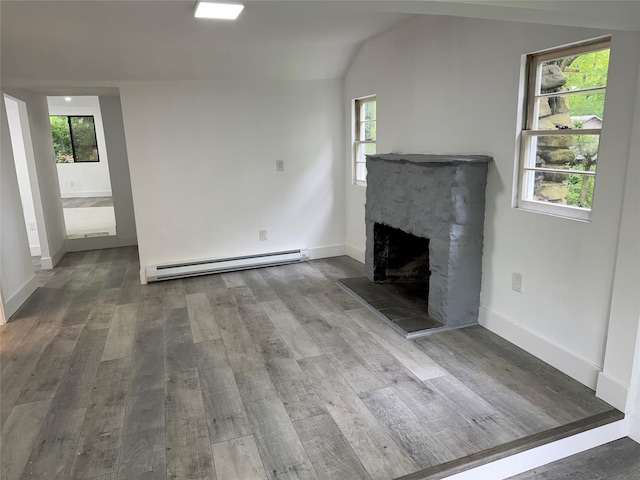 3 Brookside Trl, Monroe, NY 10950 - unfurnished living room featuring a baseboard heating unit, wood finished floors, a stone fireplace, and baseboards