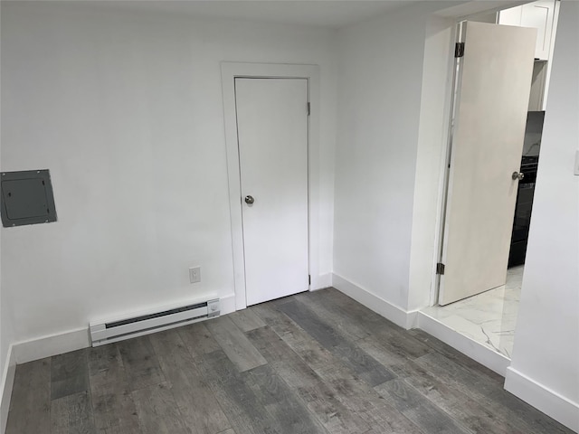 3 Brookside Trl, Monroe, NY 10950 - unfurnished room with a baseboard heating unit, wood finished floors, electric panel, and baseboards