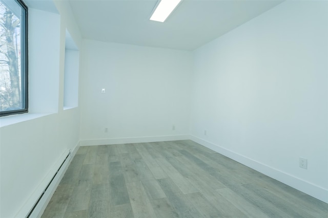 3 Brookside Trl, Monroe, NY 10950 - empty room with a baseboard radiator, light wood finished floors, and baseboards