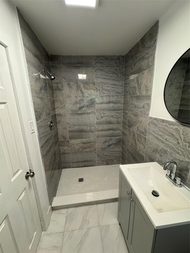 3 Brookside Trl, Monroe, NY 10950 - bathroom with marble look tile flooring, a tile shower, vanity, and tile walls