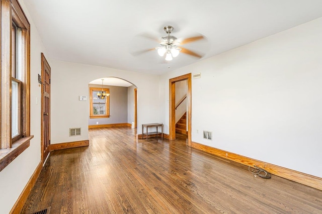 empty room featuring dark hardwood / wood-style flooring and ceiling fan