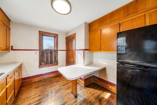 kitchen featuring black refrigerator and light wood-type flooring