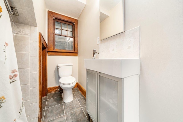 bathroom with tile patterned floors, vanity, and toilet