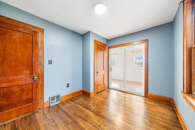 empty room with hardwood / wood-style flooring