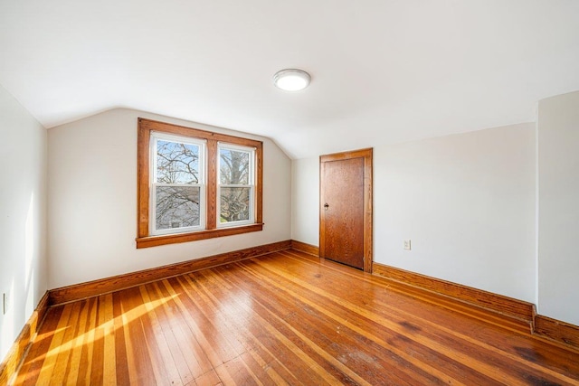 bonus room featuring hardwood / wood-style flooring and vaulted ceiling