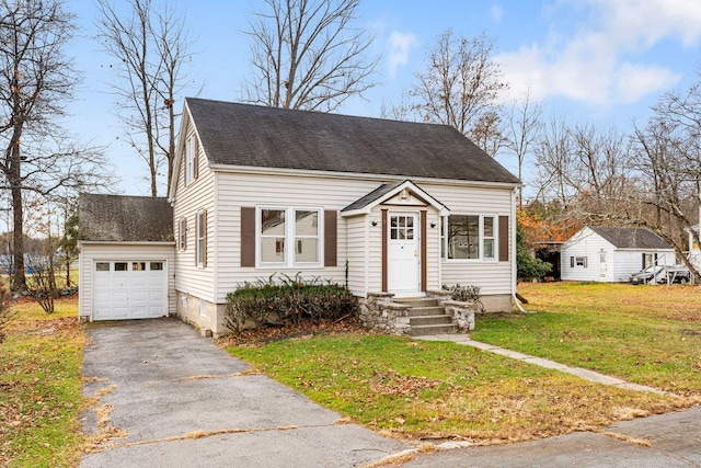 view of front facade featuring a garage, an outbuilding, and a front yard