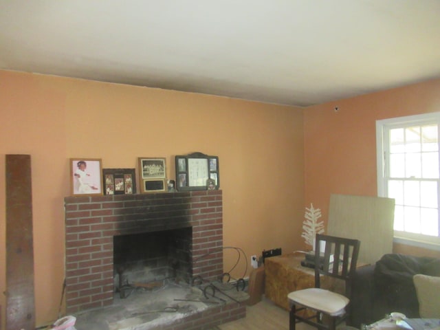 living room featuring a brick fireplace