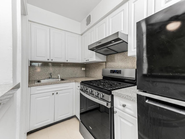 kitchen with sink, ventilation hood, backsplash, and stainless steel range with gas stovetop