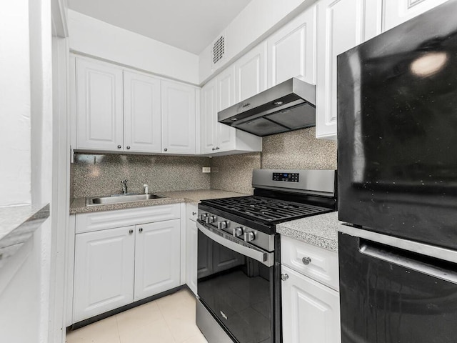 5235 Post Rd Unit 3H, Bronx, NY 10471 - kitchen with freestanding refrigerator, wall chimney range hood, stainless steel gas stove, a sink, and white cabinetry
