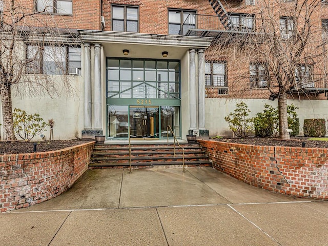 5235 Post Rd Unit 3H, Bronx, NY 10471 - view of exterior entry featuring brick siding and cooling unit