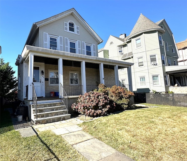 view of front of home featuring a porch and a front lawn